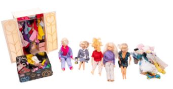 Five various dolls together with a wardrobe containing a collection of clothes and