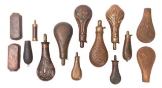 A collection of various brass and copper powder flasks, various decorated designs,