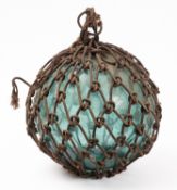 A Japanese 12 inch green glass fishing float, with ropework.