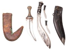 A kukri knife, the plated blade with horn handle and leather scabbard,