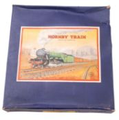 A Hornby O gauge clockwork 0-4-0 passenger train set.