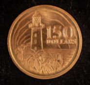 A Singapore 150 Dollars gold coin.