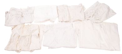 A collection of various ladies and childrens white dresses and gowns.