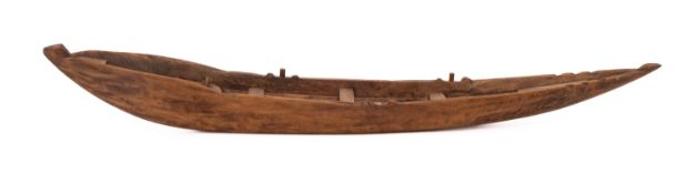 Two hand carved models of rowing boats.