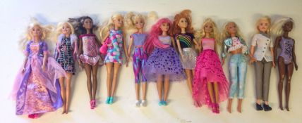 Twelve Mattel Barbie dolls.