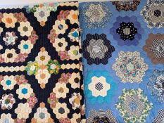Two patchwork quilts of floral design.