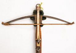 A 19th Century Continental walnut and bone inlaid crossbow.