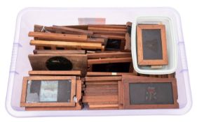 A collection of mahogany framed magic lantern slides. Including single slip, statics and frames etc.