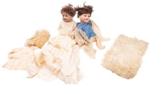 Two early 20th Century bisque head dolls. Both with painted faces and applied brunette wigs.