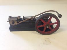 A Stuart number 8 single piston engine. Mounted on a cast plinth, 22cm long.