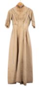 A late 19th Century cream and blue pin stripe full length dress.