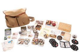 A collection of fly fishing accessories in a Brady fishing bag.