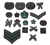A collection of various regimental cloth patches including Wells Cathedral OTC and others.