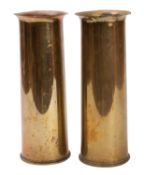 Two WWI era shell case vases. Having fluted tops and stamps to the base, 29cm high.