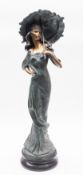A painted resin model of a maiden with a parasol,