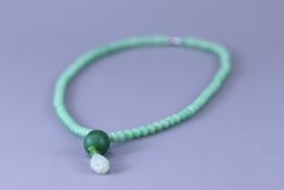 A Chinese pale Apple Green Jadeite Prayer Bead Necklace,
