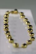 A Charles de Temple Black Onyx Bead Bracelet wrapped in 18 carat Gold, signed c de t, and dated 1976