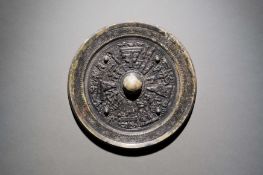 A Bronze Circular Mirror featuring the 