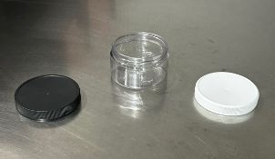 (600) 4oz Plastic Jars with Black and White Lids (count is approximate)
