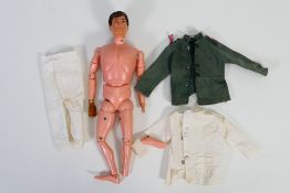 Action Man - Palitoy - An unboxed vintage flock hair Action Man with some clothing.