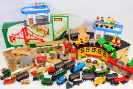 Brio - A quantity of Brio wooden train system including engine house, trains, buildings,