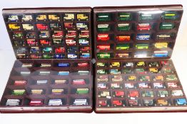 Lledo - 100 Lledo diecast model vehicles contained within four wall mounted flock display cases