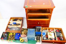 Meccano - A three drawer wooden cabinet containing a large quantity of Meccano parts.