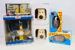 Wallace & Gromit - The Simpsons - A group of boxed items including 2 x Persil Happy Feet Penguins,