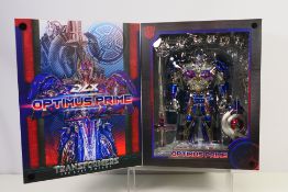 Three Zero - A boxed Transformers The Last Knight Optimus Prime DLX figure # 3Z0457.