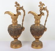 A pair of late 19th Century French bronze and gilt bronze Bacchanalian garniture ewers