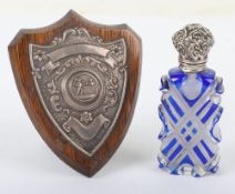 An unmarked silver topped scent bottle