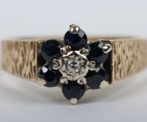 A 9ct sapphire and chip diamond ring