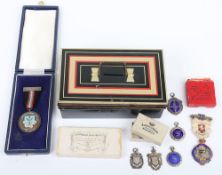 A selection of silver and enamel badges,