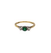 An emerald and diamond three stone ring,