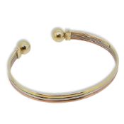 A 9ct three colour gold torc bangle,