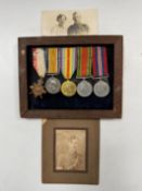 A mounted set of medals together with two photographs,