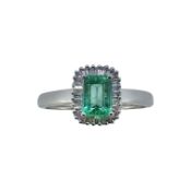 An 18ct gold emerald and diamond cluster ring,