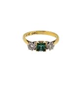 An emerald and diamond three stone ring,