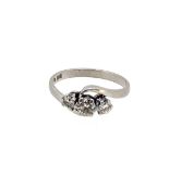 A platinum three stone diamond ring,