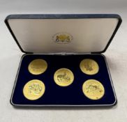 Royal Mint for Hampton & Sons - A set of five 22ct gold celebratory medals,