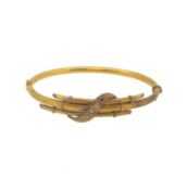 An Edwardian diamond set bangle,