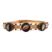 A black mother of pearl bangle