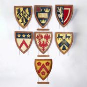A collection of painted wood university heraldic shields