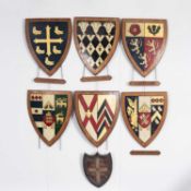 A collection of painted plaster University and School heraldic shields