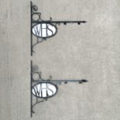A near pair of W. H. Smith wrought iron brackets