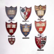 A collection of painted plaster university heraldic shields