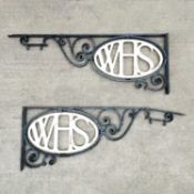 A pair of large black painted wrought iron brackets
