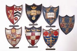 A collection of painted plaster school and university heraldic shields