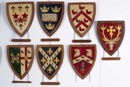 A collection of painted wood university heraldic shields