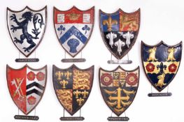 A collection of painted plaster school heraldic shields